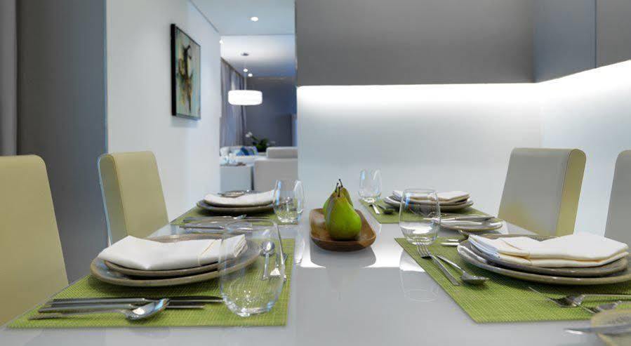Damac Maison The Vogue Dubai Bagian luar foto A table set for a meal